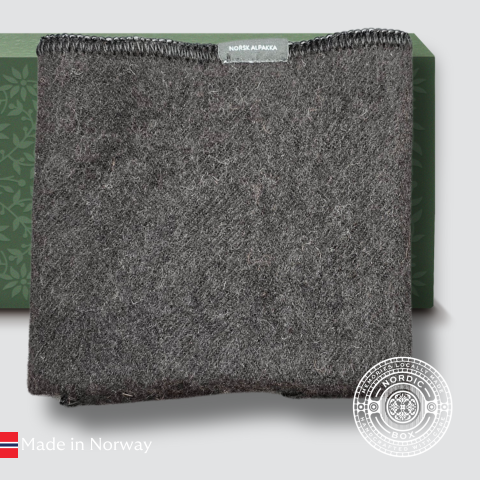 Sort sitteunderlag i alpakka